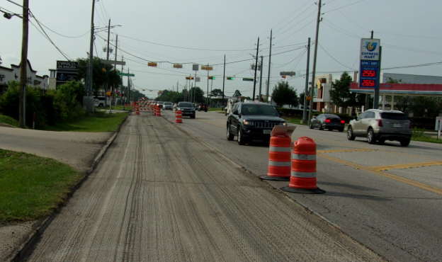 Roadway paving with traffic control barricades